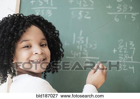African American student writing on chalkboard in classroom View Large Photo Image Stock Photo - African American student writing on chalkboard in classroom. Fotosearch