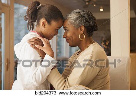Stock Image - African American woman and granddaughter smiling. Fotosearch