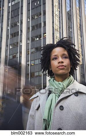 Stock Image - African American woman in urban scene. Fotosearch