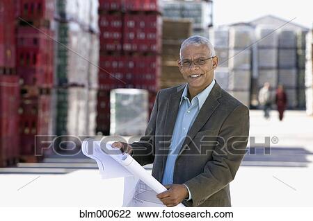 African architect reviewing blueprints at factory View Large Photo Image Stock Image - African architect reviewing blueprints at factory. Fotosearch
