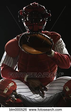 Stock Photograph - African baseball catcher gesturing during game. Fotosearch