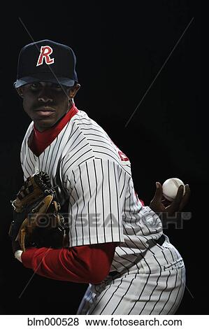 Stock Photo - African baseball player pitching. Fotosearch