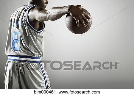 African basketball player holding basketball View Large Photo Image Stock Image - African basketball player holding basketball. Fotosearch