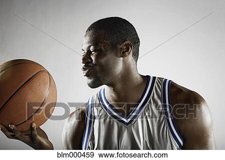 African basketball player holding basketball View Large Photo Image Stock Photo - African basketball player holding basketball. Fotosearch