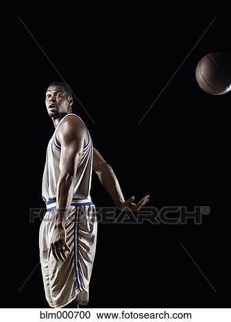 African basketball player passing basketball View Large Photo Image Stock Image - African basketball player passing basketball. Fotosearch