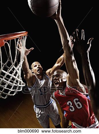 Stock Image - African basketball player scoring. Fotosearch