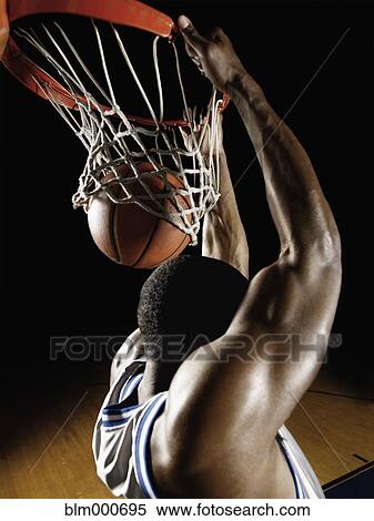 Stock Photography - African basketball player scoring. Fotosearch