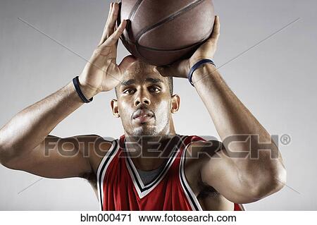 Stock Image - African basketball player shooting basketball. Fotosearch