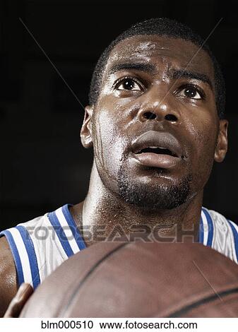 Stock Image - African basketball player shooting basketball. Fotosearch