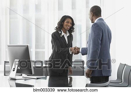 Stock Photo - African business people shaking hands. Fotosearch