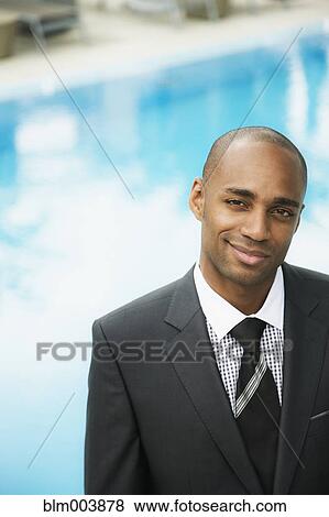 African businessman smiling poolside View Large Photo Image Stock Photo - African businessman smiling poolside. Fotosearch