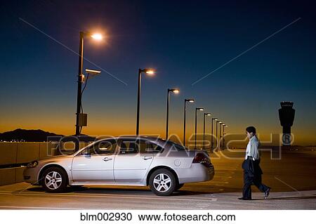African businessman walking to car in parking lot View Large Photo Image Stock Image - African businessman walking to car in parking lot. Fotosearch
