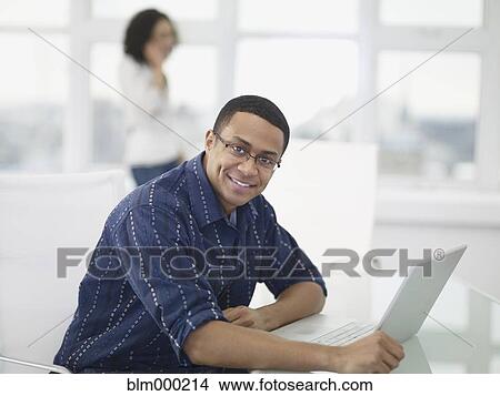 African businessman working on laptop in office View Large Photo Image Picture - African businessman working on laptop in office. Fotosearch