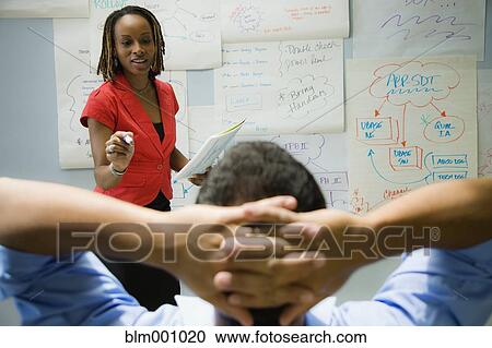 African businesswoman explaining idea to co-worker View Large Photo Image Stock Image - African businesswoman explaining idea to co-worker. Fotosearch