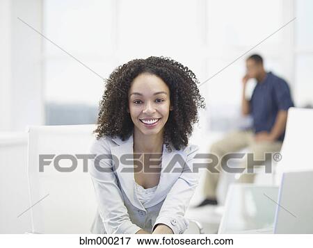 African businesswoman smiling in office View Large Photo Image Stock Photo - African businesswoman smiling in office. Fotosearch