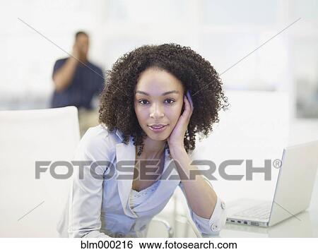 Stock Photograph - African businesswoman with head in hands. Fotosearch