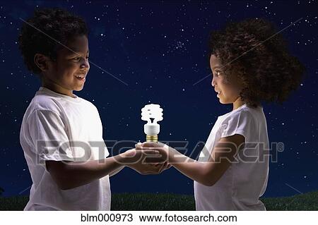 African children holding glowing cfl lightbulb View Large Photo Image Stock Image - African children holding glowing cfl lightbulb. Fotosearch