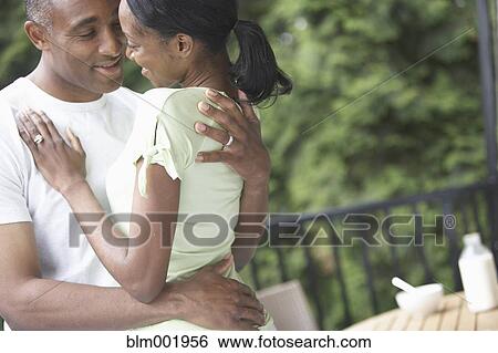 African couple hugging and smiling at each other outdoors View Large Photo Image Stock Photograph - African couple hugging and smiling at each other outdoors. Fotosearch