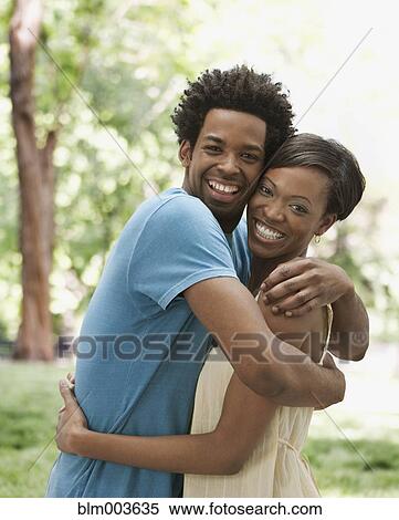 African couple hugging in park View Large Photo Image Stock Photography - African couple hugging in park. Fotosearch