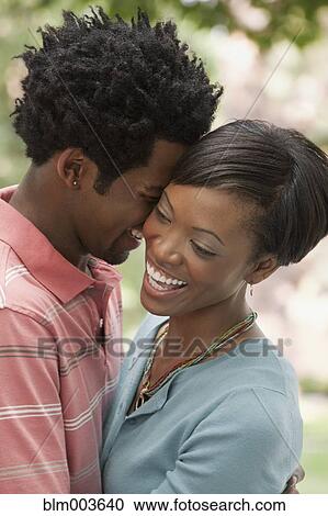 Stock Image - African couple hugging. Fotosearch