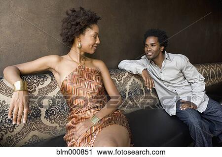 Stock Image - African couple sitting in nightclub. Fotosearch