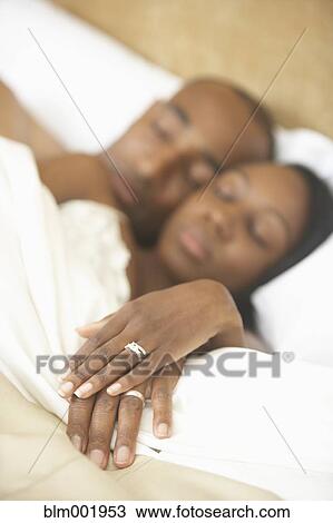 African couple sleeping in bed View Large Photo Image Stock Image - African couple sleeping in bed. Fotosearch