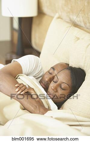 African couple sleeping in bed View Large Photo Image Stock Photography - African couple sleeping in bed. Fotosearch