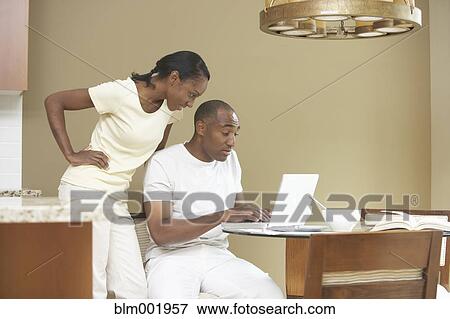 African couple using laptop in kitchen View Large Photo Image Stock Photo - African couple using laptop in kitchen. Fotosearch