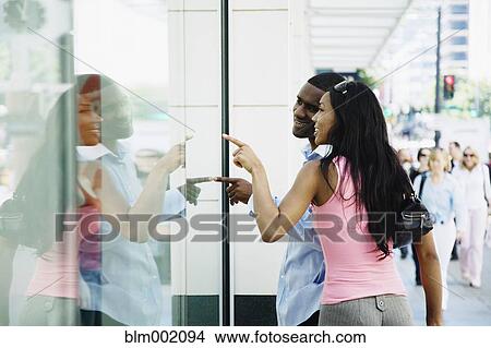 Picture - African couple window shopping. Fotosearch
