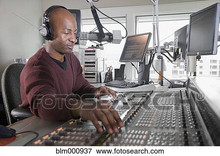 Stock Photo - African dj working at radio station. Fotosearch