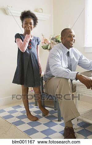 Stock Photo - African father and daughter playing together. Fotosearch