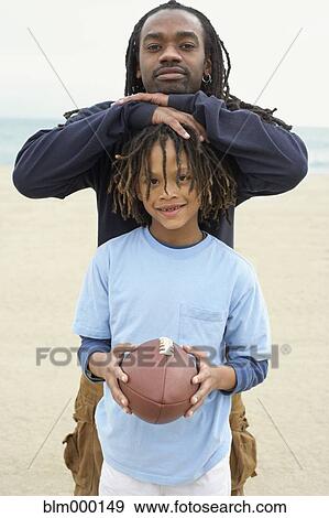 Stock Photo - African father and son with football. Fotosearch