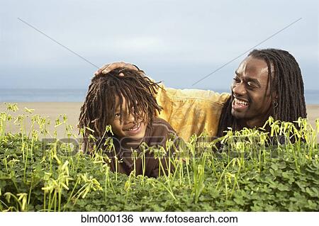African father patting son’s head View Large Photo Image Stock Photograph - African father patting son’s head. Fotosearch