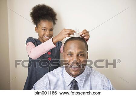 African father wearing daughter's tiara View Large Photo Image Stock Photograph - African father wearing daughter's tiara. Fotosearch
