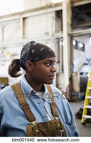 Stock Image - African female worker in warehouse. Fotosearch