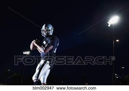 Stock Photo - African football player throwing football. Fotosearch