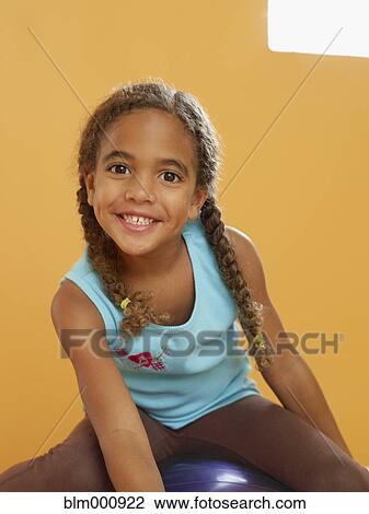 African girl sitting on exercise ball View Large Photo Image Stock Image - African girl sitting on exercise ball. Fotosearch
