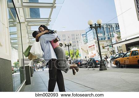 African hugging on sidewalk View Large Photo Image Stock Image - African hugging on sidewalk. Fotosearch