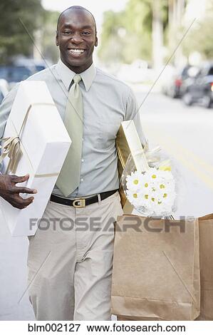 Stock Photo - African man carrying gifts. Fotosearch