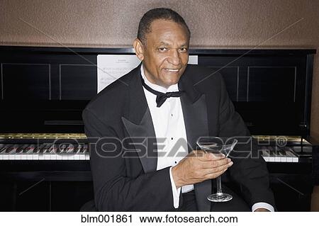 African man drinking cocktail in front of piano View Large Photo Image Stock Image - African man drinking cocktail in front of piano. Fotosearch