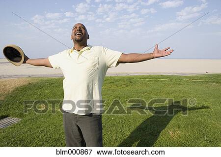 African man enjoying the sun at beach View Large Photo Image Stock Photo - African man enjoying the sun at beach. Fotosearch