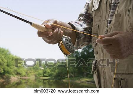 Stock Image - African man fishing. Fotosearch