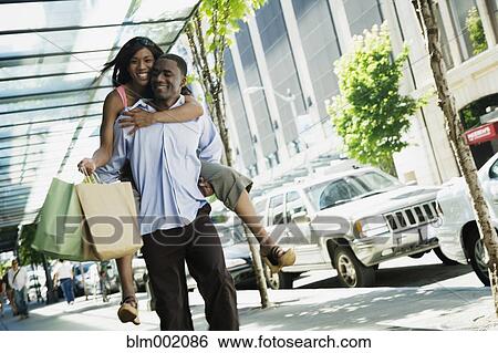 African man giving girlfriend piggyback ride View Large Photo Image Stock Photograph - African man giving girlfriend piggyback ride. Fotosearch