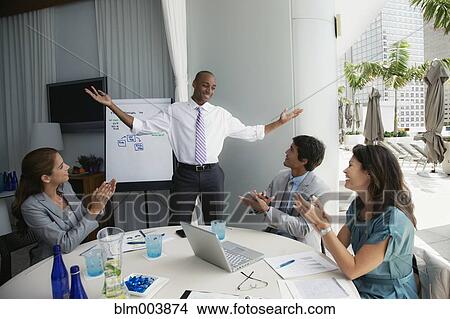 Picture - African man giving presentation on patio. Fotosearch