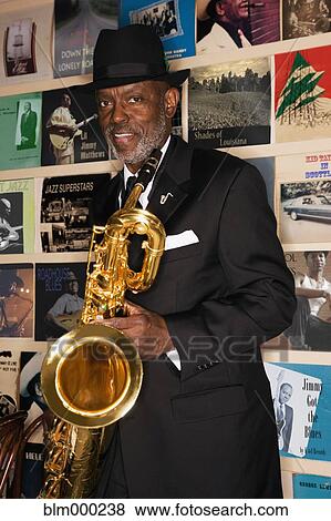 African man holding saxophone View Large Photo Image Stock Photo - African man holding saxophone. Fotosearch