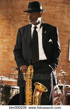 Stock Photo - African man holding saxophone. Fotosearch