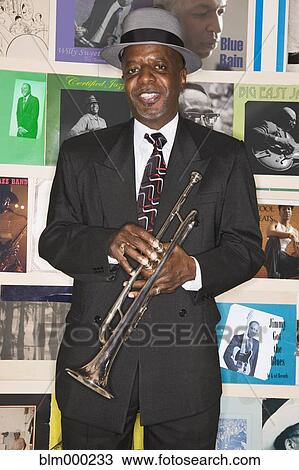 African man holding trumpet View Large Photo Image Stock Image - African man holding trumpet. Fotosearch