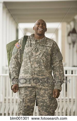 Stock Image - African man in military uniform laughing. Fotosearch