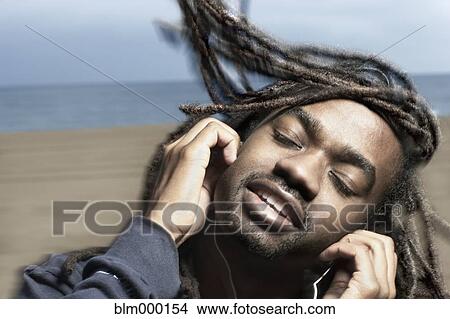 African man listening to headphones View Large Photo Image Picture - African man listening to headphones. Fotosearch