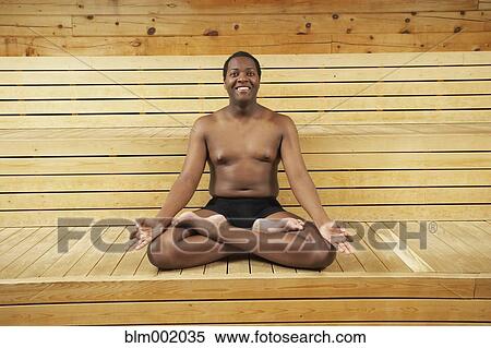 Stock Photography - African man meditation in sauna. Fotosearch